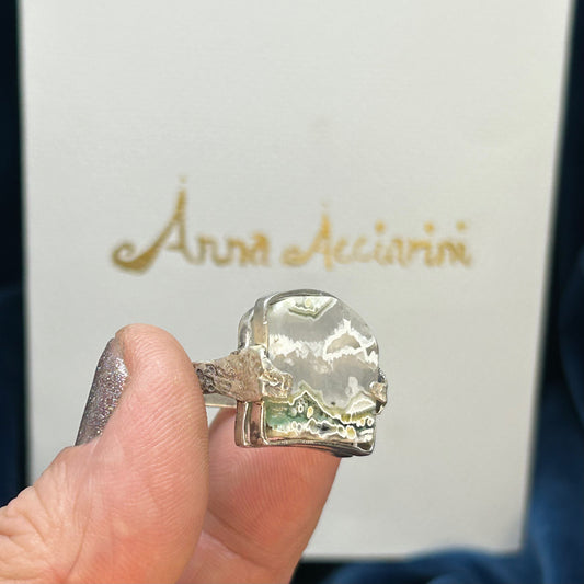 A stunning heavy rain with a slice of polished ocean Jasper, representing the sea and the sky. Textured shank continues on the pattern all the way around the ring. the stone is clear in places and has beautiful, moss green and green druzy, a sparkly quartz embedded in the stone.